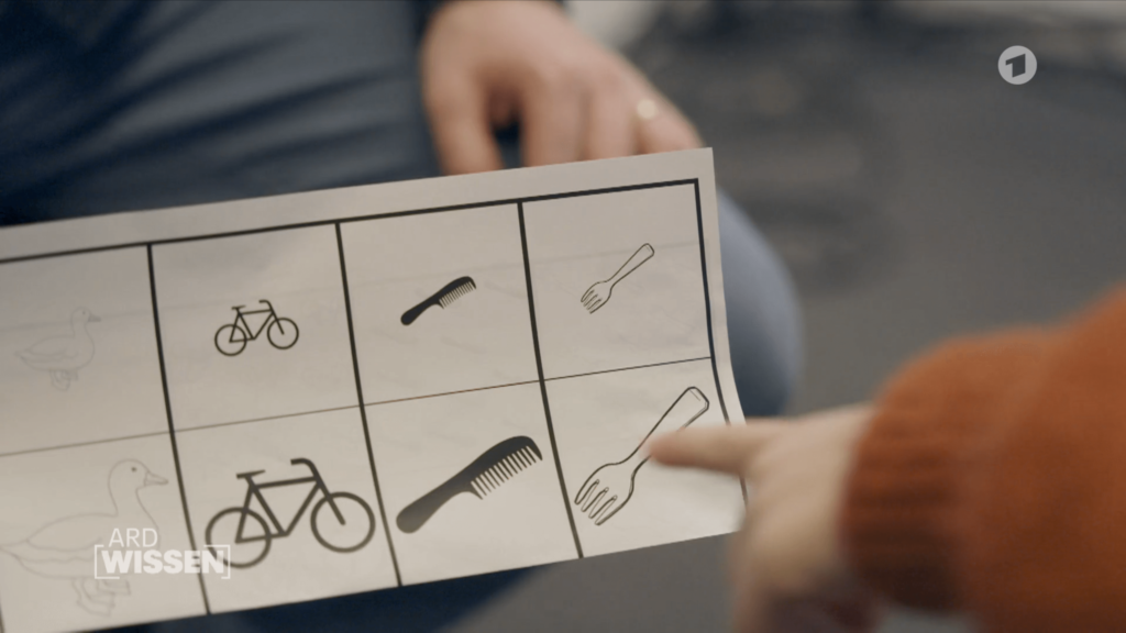 Screenshot vom ARD Wissen Video. Kinderhand zeigt auf eins von vielen Symbolen.